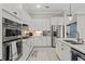Modern kitchen features stainless steel appliances, ample cabinetry, and quartz countertops at 14560 Eagle Branch Dr, Nokomis, FL 34275