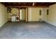 Spacious unfinished basement area with laundry hookups and utility features; versatile potential at 7314 Patio Row, Hudson, FL 34667