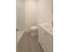 Well-lit bathroom with a tiled shower, toilet, and a white vanity with modern fixtures at 7314 Patio Row, Hudson, FL 34667