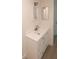 Bathroom featuring a white vanity with modern fixtures, countertop, and mirror at 7314 Patio Row, Hudson, FL 34667