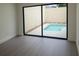 Bedroom featuring an indoor pool through sliding glass doors at 7314 Patio Row, Hudson, FL 34667