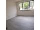 Bright bedroom with a large window and hardwood floors at 7314 Patio Row, Hudson, FL 34667