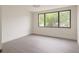 Bright bedroom with wood flooring, a large window providing natural light and beautiful outdoor views at 7314 Patio Row, Hudson, FL 34667