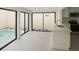 Bright kitchen with white cabinets and counters, seamlessly connected to outdoor pool area at 7314 Patio Row, Hudson, FL 34667