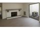 Bright living room with fireplace and sliding glass doors to a patio at 7314 Patio Row, Hudson, FL 34667