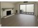 Bright living room featuring a fireplace, gray floors and sliding glass doors at 7314 Patio Row, Hudson, FL 34667