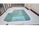 Backyard view of the pool with a set of steps and light blue tile at 7314 Patio Row, Hudson, FL 34667