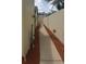 Narrow side yard with rock covering ground at 7314 Patio Row, Hudson, FL 34667