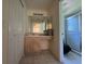 Bathroom with a light wood vanity, a large mirror, and a glass door shower at 2305 De Vore St, North Port, FL 34291