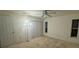 Bedroom featuring neutral carpet, ceiling fan and natural light from the two windows at 2305 De Vore St, North Port, FL 34291