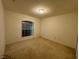 Simple bedroom with large window, neutral walls and basic lighting at 2305 De Vore St, North Port, FL 34291