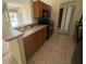 Efficient kitchen featuring wood cabinetry and a breakfast bar at 2305 De Vore St, North Port, FL 34291