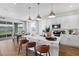 A bright open kitchen with white cabinets, stainless steel appliances, island seating, and adjacent dining area at 5307 Wolf Creek Dr, Apollo Beach, FL 33572
