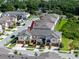 Aerial view of multiple townhomes with gray roofs and light colored siding in a planned community at 5424 Companion Ln, Tampa, FL 33619