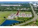 Aerial view of community townhomes, pond, and highway, showcasing the neighborhood layout at 5424 Companion Ln, Tampa, FL 33619