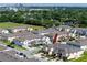 An aerial view of gray roofed townhomes and manicured lawns with Tampa skyline in the distance at 5424 Companion Ln, Tampa, FL 33619