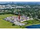 An aerial view of a townhome community surrounded by greenery, a pond, and a parking lot at 5424 Companion Ln, Tampa, FL 33619