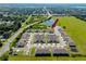 Aerial view of townhomes surrounded by nature with pond, playground and well-kept green spaces at 5424 Companion Ln, Tampa, FL 33619