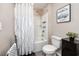 Bathroom featuring a tub and shower combination with shower curtain, toilet, and decor at 5424 Companion Ln, Tampa, FL 33619