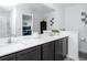 Bathroom featuring a double vanity, gray cabinets, white countertop and a view into the primary bedroom at 5424 Companion Ln, Tampa, FL 33619