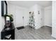 Clean entryway boasts gray wood floors, a white front door, and stylish decorative shelving at 5424 Companion Ln, Tampa, FL 33619