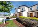 Eye-level exterior of a two-story townhome showcasing an attached garage, landscaping, and inviting entrance at 5424 Companion Ln, Tampa, FL 33619