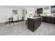 Modern kitchen features an island with granite countertop, stainless appliances, and a dining area nearby at 5424 Companion Ln, Tampa, FL 33619