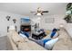 Open concept living room features a sectional sofa, fireplace and gray wood floors at 5424 Companion Ln, Tampa, FL 33619