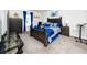 Well-lit main bedroom with a plush carpet, complemented by dark wood furniture and bright blue accents at 5424 Companion Ln, Tampa, FL 33619