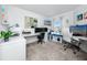 Bright home office with multiple work stations, carpeting, modern decor, and a bench by the window at 5424 Companion Ln, Tampa, FL 33619