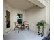 Small covered back patio with concrete floor and two chairs with colorful pillows at 5424 Companion Ln, Tampa, FL 33619