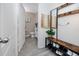 Hallway and powder room with gray wood floors, modern mirror, decor, and half-bathroom at 5424 Companion Ln, Tampa, FL 33619