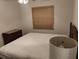 A bedroom featuring a simple bed, natural light and minimal decor at 5905 Cleveland Dr, Punta Gorda, FL 33982