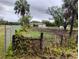 Exterior view of a house with a garage and outbuilding surrounded by grassy areas and trees at 5905 Cleveland Dr, Punta Gorda, FL 33982