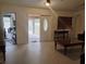 Bright living room featuring tile floors, ceiling fan and access to garage and front porch at 5905 Cleveland Dr, Punta Gorda, FL 33982