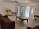Spacious living room featuring tile floors, neutral walls and dark furniture at 5905 Cleveland Dr, Punta Gorda, FL 33982
