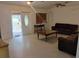 Living room featuring tile floors, dark furniture, ceiling fan, and natural light at 5905 Cleveland Dr, Punta Gorda, FL 33982