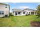 Lush backyard with green grass, landscaping and privacy; neighboring homes are visible at 6038 Jensen View Ave, Apollo Beach, FL 33572