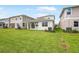 View of a well-maintained backyard with lush green grass and adjacent home exteriors at 6038 Jensen View Ave, Apollo Beach, FL 33572