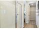 Shower and toilet room featuring white tiling and a glass shower door in an airy interior at 6038 Jensen View Ave, Apollo Beach, FL 33572