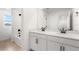 Bright bathroom features double sinks, white cabinetry, quartz countertop and tub/shower combo at 6038 Jensen View Ave, Apollo Beach, FL 33572