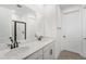 Modern bathroom with double sinks, quartz countertop, and a glass-enclosed shower at 6038 Jensen View Ave, Apollo Beach, FL 33572