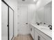 Modern bathroom featuring double sinks, a quartz countertop, and a glass-enclosed shower at 6038 Jensen View Ave, Apollo Beach, FL 33572