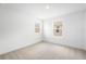 Empty bedroom showcasing two windows and plush carpeting at 6038 Jensen View Ave, Apollo Beach, FL 33572