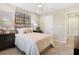 Bedroom with a black dresser, carpeted floors, modern art, and a comfortable bed at 6038 Jensen View Ave, Apollo Beach, FL 33572