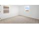 Brightly lit bedroom features two large windows with views of the neighborhood and carpeted floors at 6038 Jensen View Ave, Apollo Beach, FL 33572