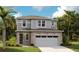 Charming two-story home with stone accents, a two-car garage, and lush landscaping at 6038 Jensen View Ave, Apollo Beach, FL 33572