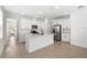 Bright kitchen with island, stainless appliances, white cabinetry, and modern lighting at 6038 Jensen View Ave, Apollo Beach, FL 33572