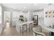 Spacious white kitchen with a central island, stainless steel appliances, and an adjacent dining area at 6038 Jensen View Ave, Apollo Beach, FL 33572