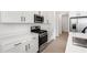 Modern kitchen featuring white cabinets, quartz countertops, stainless steel appliances, and tile flooring at 6038 Jensen View Ave, Apollo Beach, FL 33572